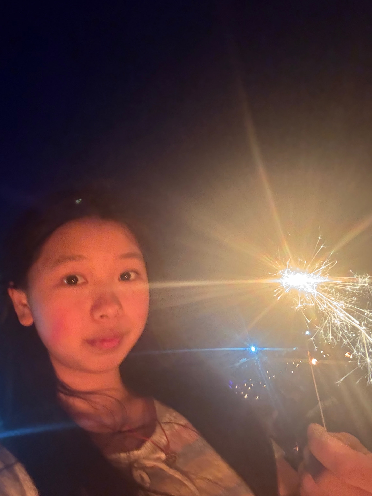 Alice holding a sparkler at night